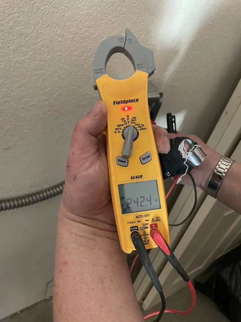 Voltage testing with clamp meter during Whole House Surge Protector in Upper Salford